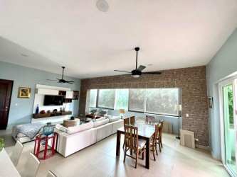 Bedroom with balcony access and garden views at PH Punta Barco Resort Panama