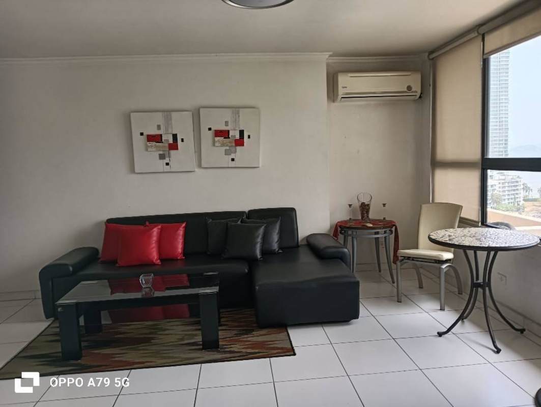 Living room with sectional sofa, large window overlooking ocean, glass coffee table PH BICSA Tower Panama