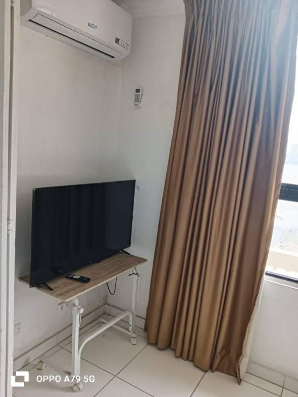 Room corner with AC, flat screen TV, beige curtains PH BICSA Tower