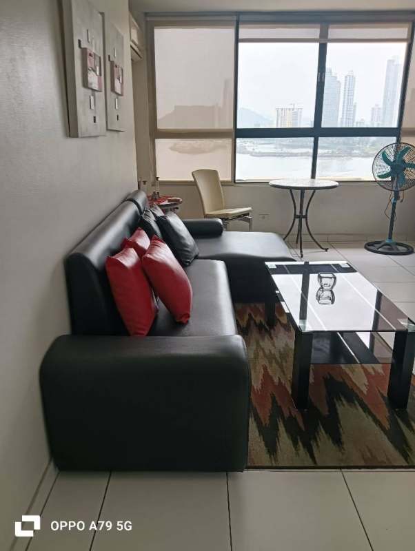 Living room with large window showing ocean view black sofa glass coffee table PH BICSA Tower Panama
