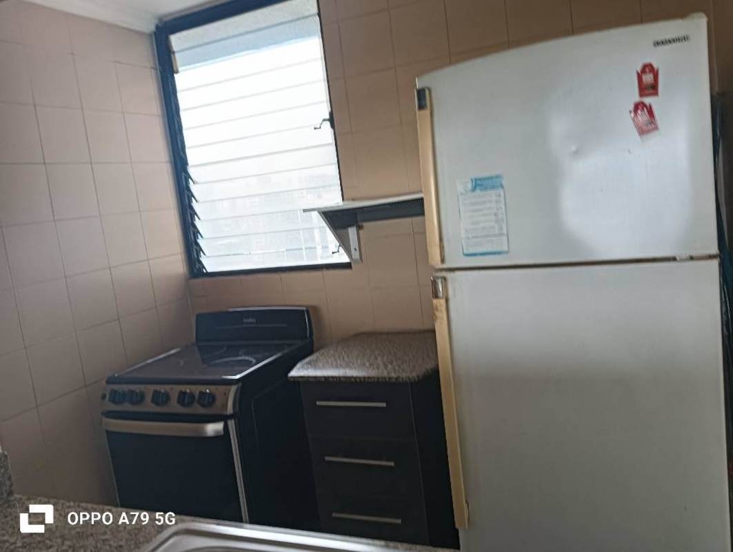 Kitchen with refrigerator gas stove beige tiles PH BICSA Tower Panama