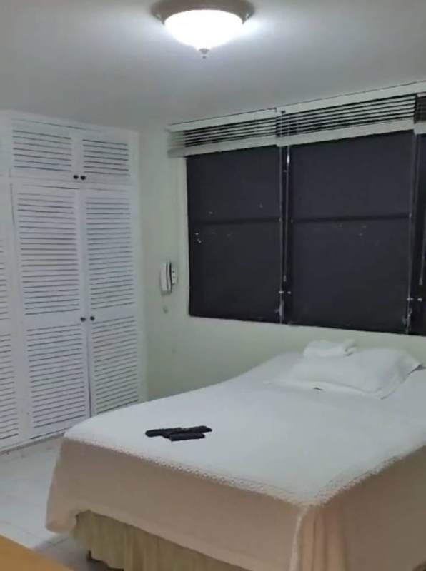 Functional kitchen with cabinets, stove, refrigerator in El Cangrejo apartment Panama City