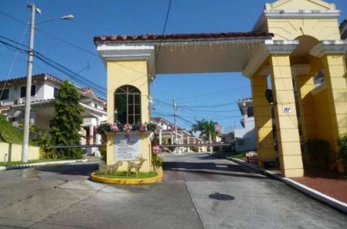 Entrance gate to PH Corona Gardens residential neighborhood with security arch and barrier