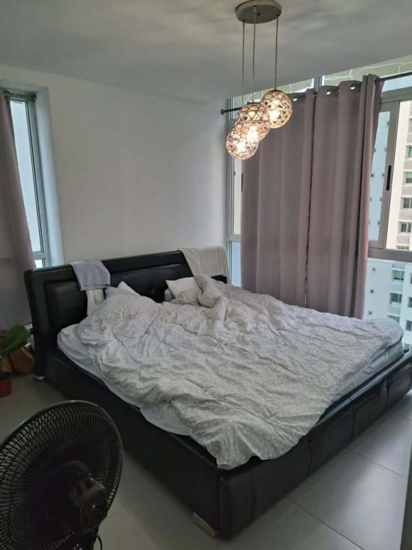 Modern kitchen with granite countertops, washer, dryer, and refrigerator at PH Colores de Bella Vista Panama City