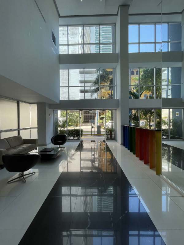 Modern bathroom with glass shower, beige tiles, and sink in PH Colores de Bella Vista Panama