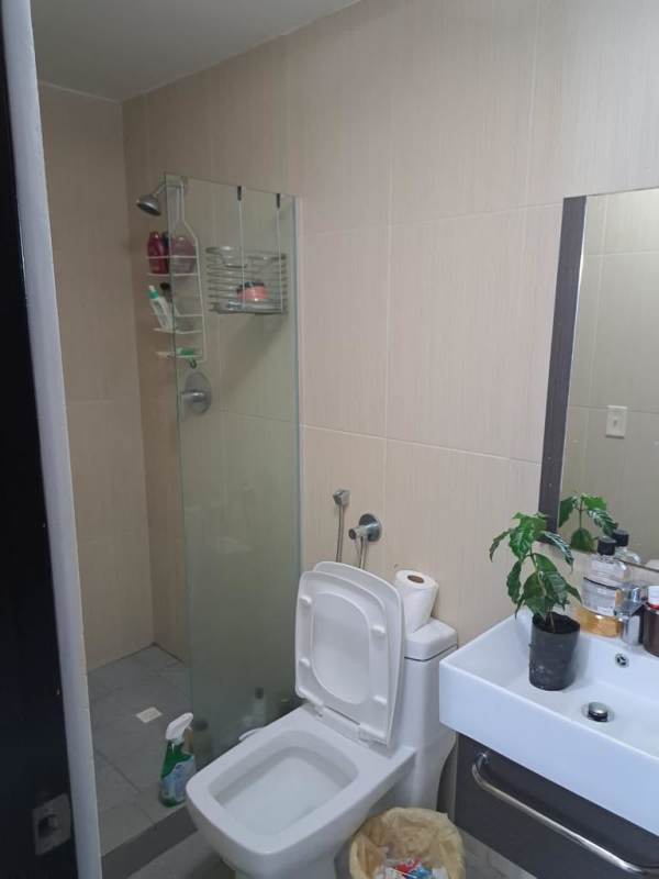 Lobby with double-height windows, colorful railing, and modern design at PH Colores de Bella Vista Panama City