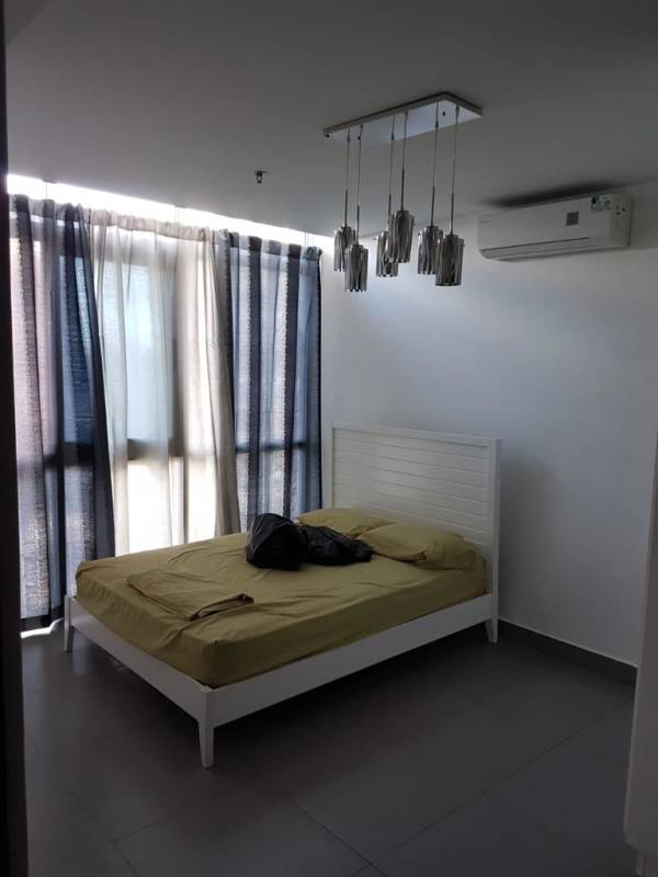 Modern kitchen with microwave, stove, granite countertop at PH Colores de Bella Vista Panama