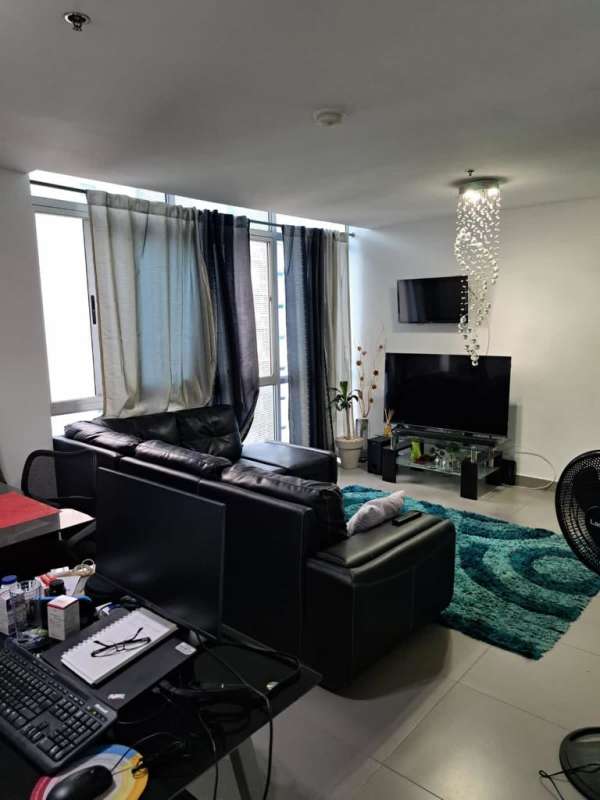 Minimalist bedroom with split AC, large window, and beige bedding at PH Colores de Bella Vista Panama City