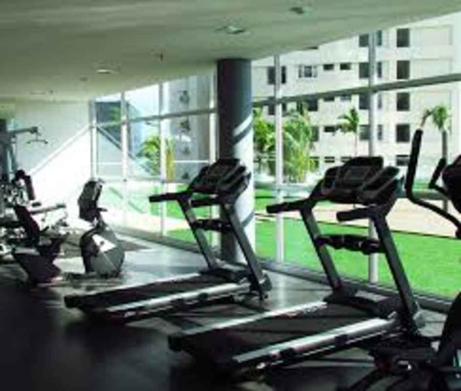 Minimalist bathroom with glass shower, wall-mounted sink, and mirror PH Colores de Bella Vista Panama