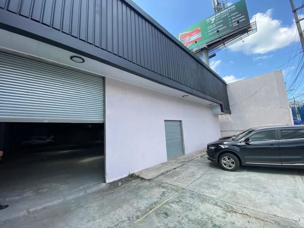 Exterior of warehouse with truck bay roll-up door and parking area La Loceria Panama