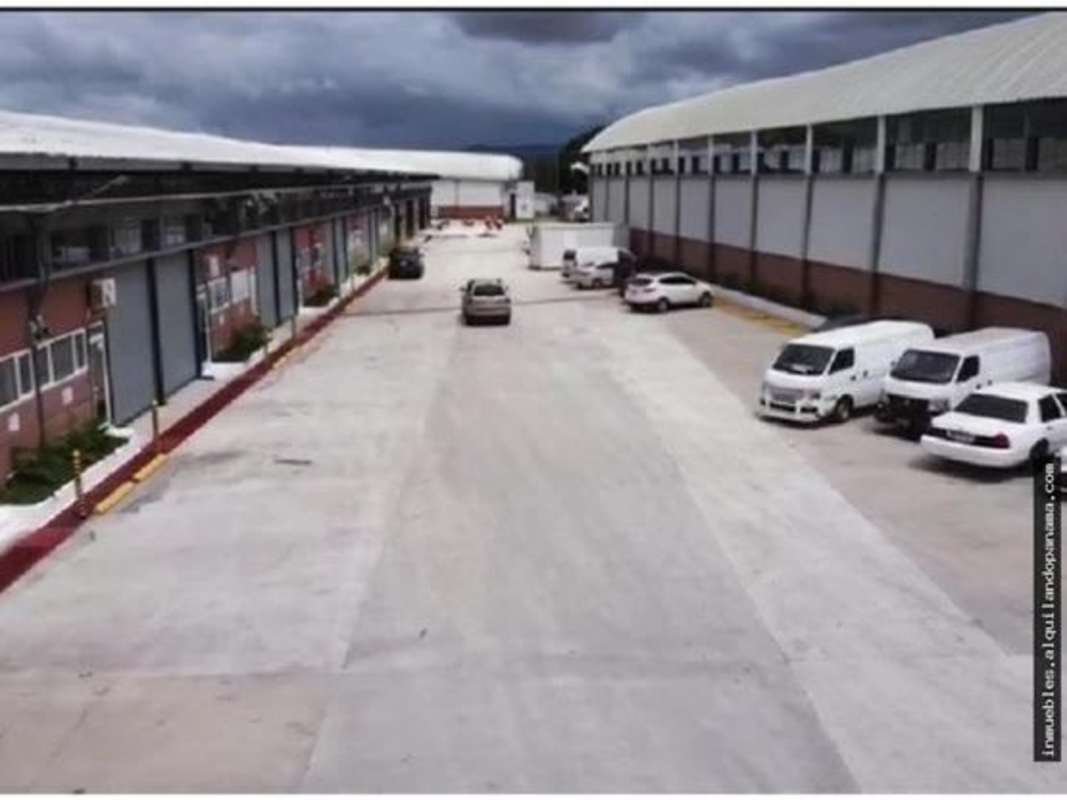 Spacious concrete driveway with access to multiple industrial warehouses Villa Zaita