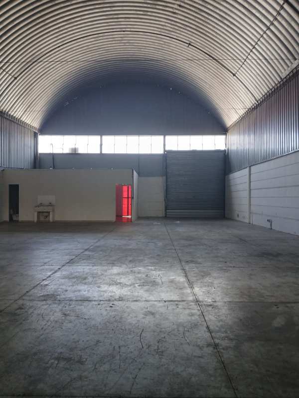 Empty warehouse interior with arched roof and concrete floor Villa Zaita Panama