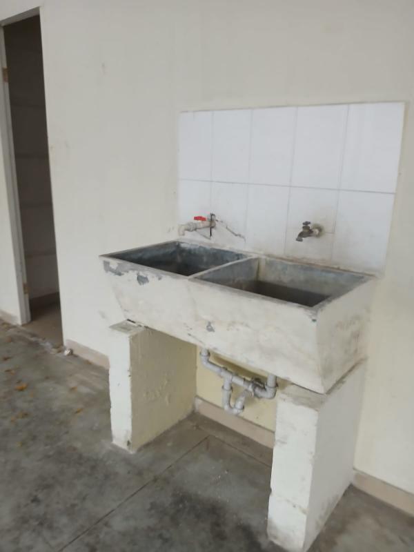 Interior of warehouse showing small enclosed area with sink and high window Villa Zaita