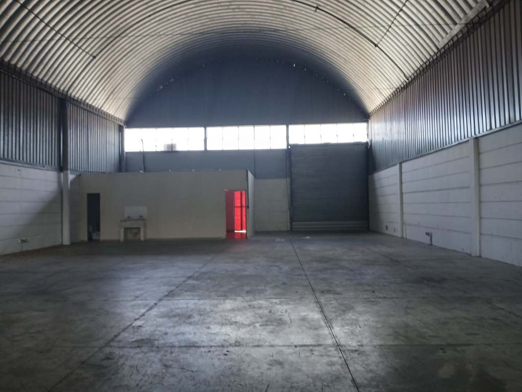 Basic bathroom inside warehouse unit with toilet and concrete floors Villa Zaita