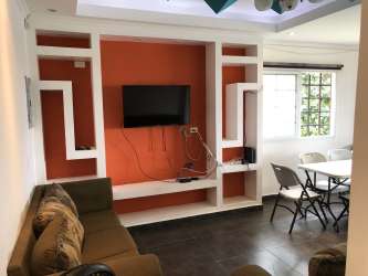 Single-story white house with covered parking and garden at Las Villas de Occidente near Río Hato Panama