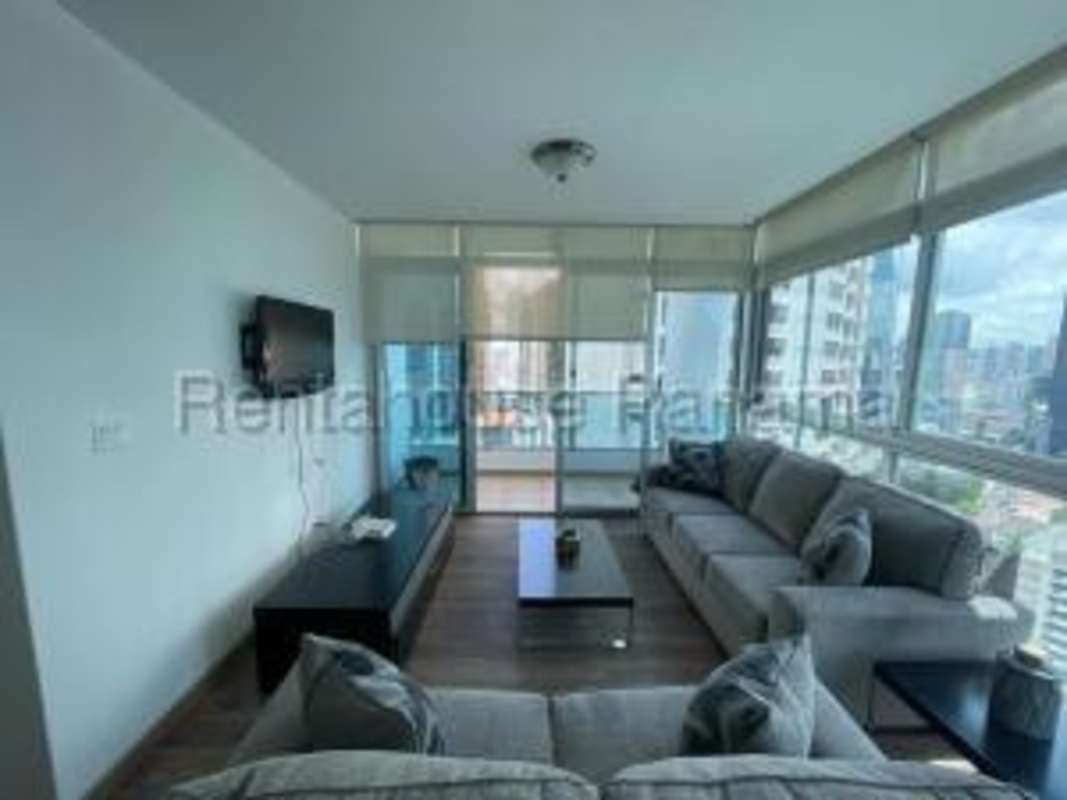 Furnished dining area with panoramic windows showing city and ocean at PH Bayfront
