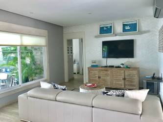 Open-plan living room with garden views at Bijao Miraflores Golf Beach Villa Panama