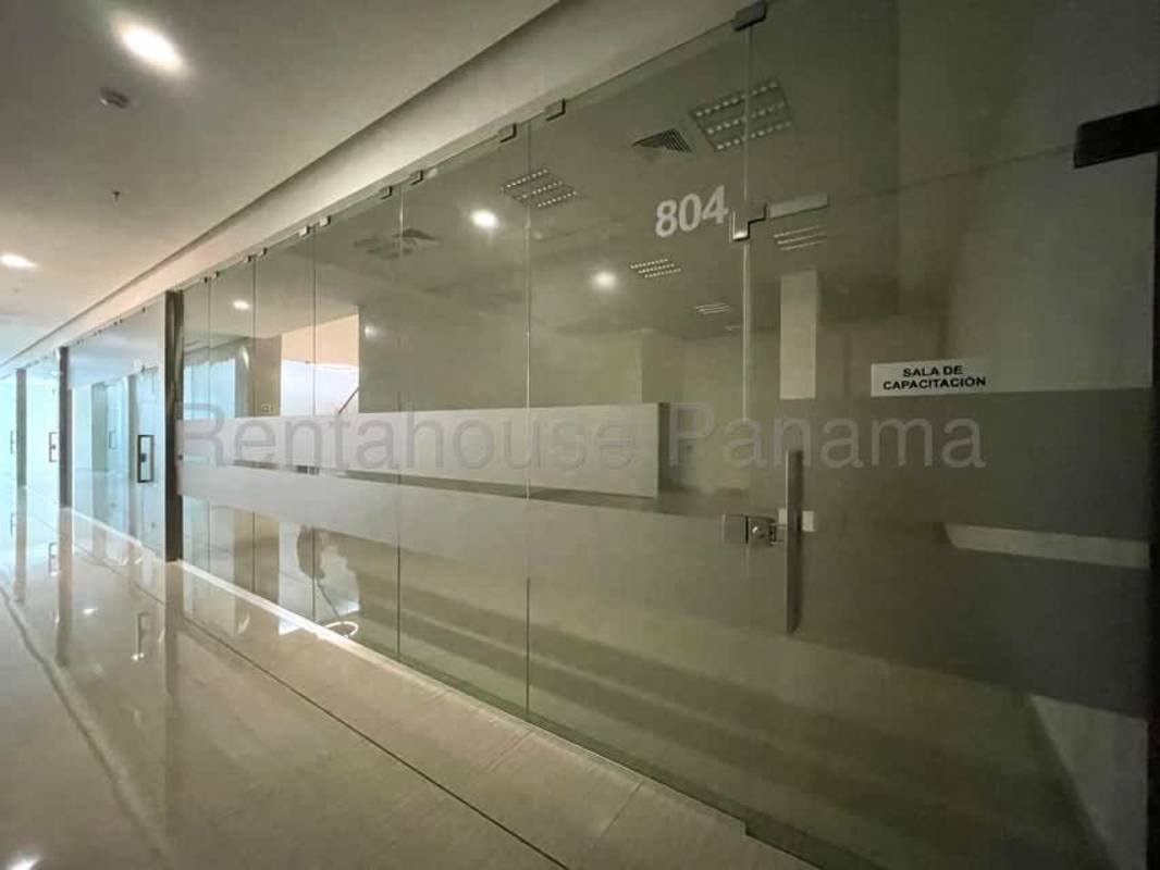 Glass-walled corridor with signs to training center at RALI Business Center Panama City