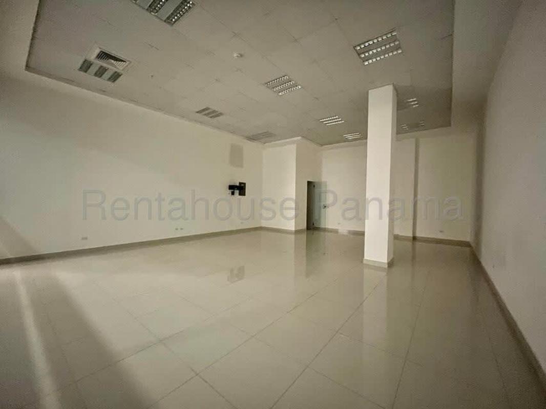 Modern cafe style lounge with eclectic decor and green wall at RALI Business Center in Panama