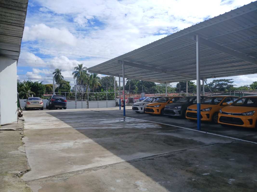 Large concrete yard with covered metal structures suited for trucks or storage in Panama City