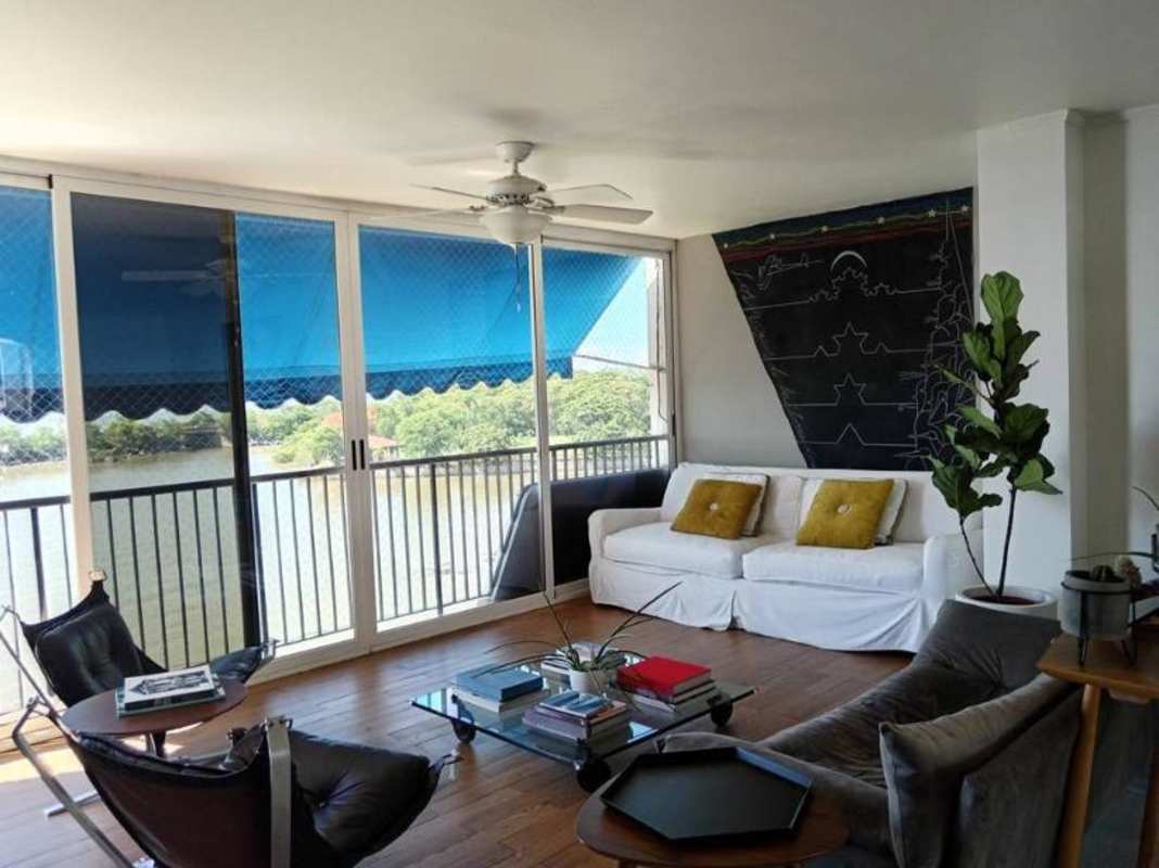 Kitchen featuring large windows, island countertop, and city skyline views in PH Las Llamas Coco del Mar Panama City