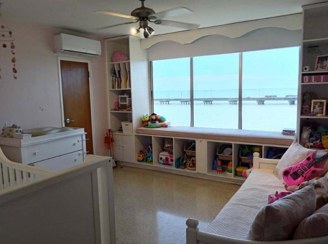Children's room with built-in shelves, play area, and ocean view window in PH Las Llamas Panama