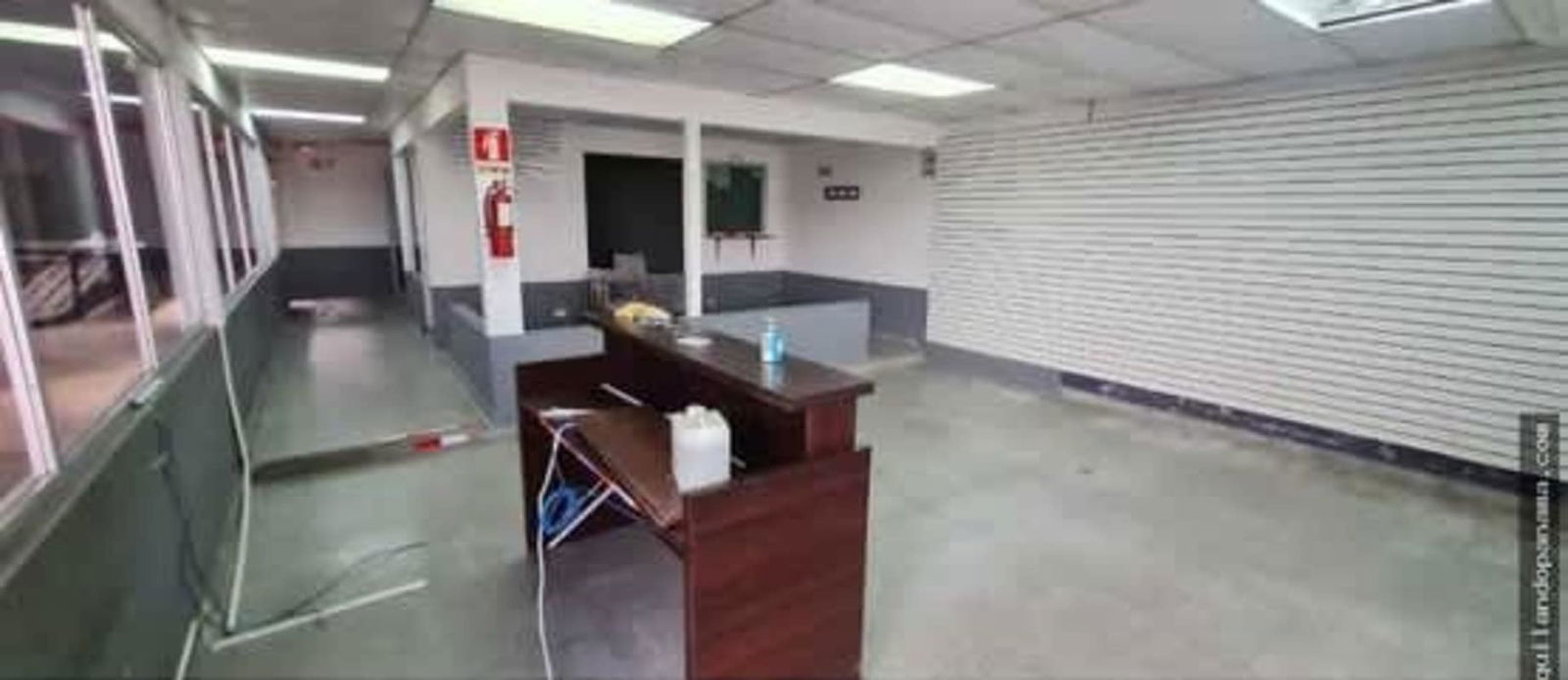 Industrial workshop with high ceilings, vehicle lift, spray booth, and equipment Panama City