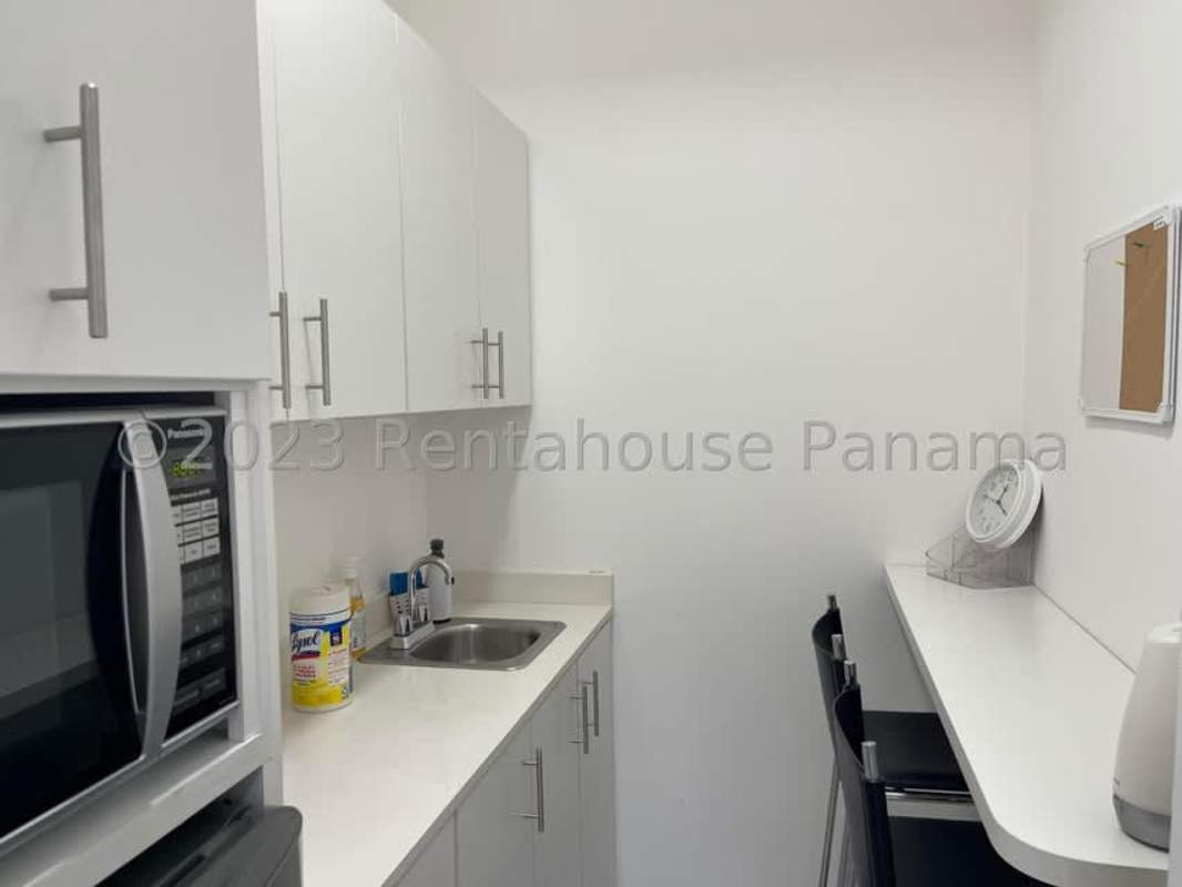 Small kitchenette with white cabinets, microwave and sink in commercial office for sale Financial Park Panama