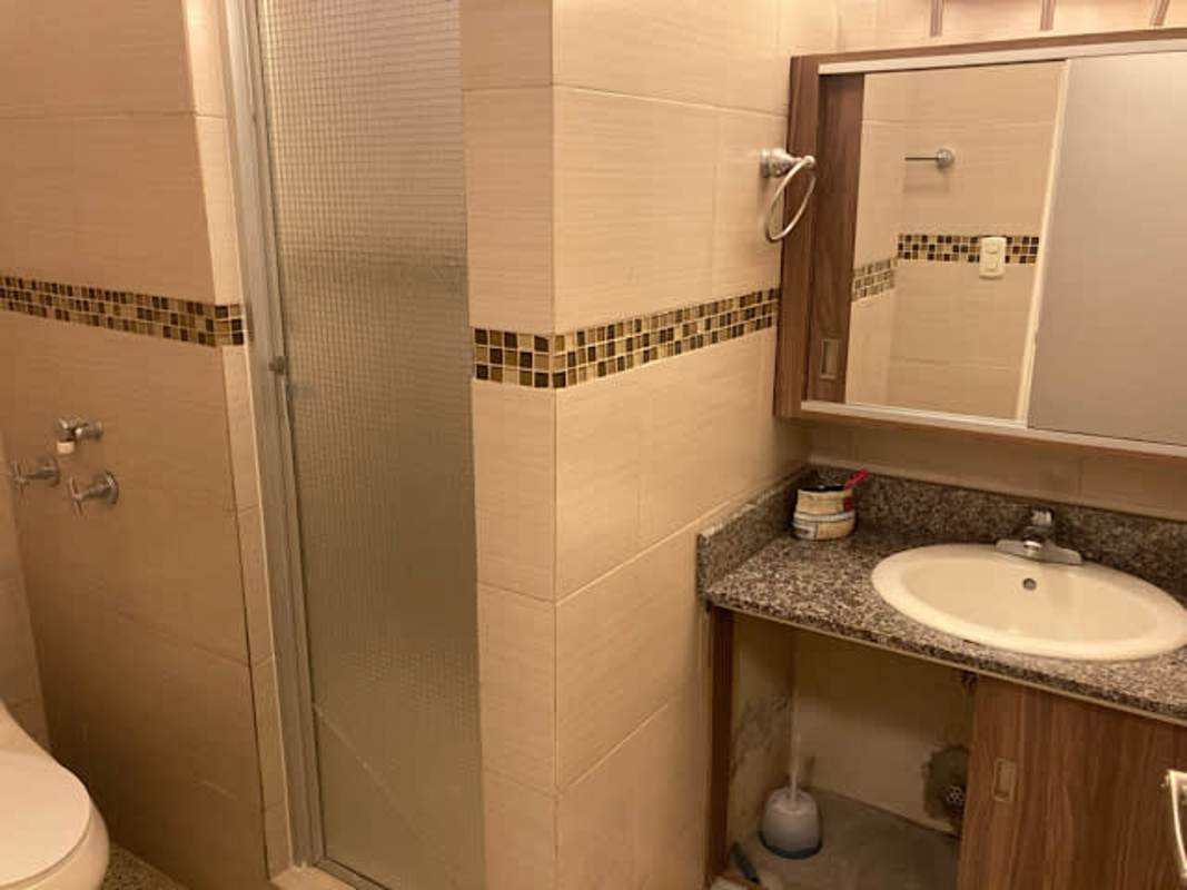 Modern bathroom with granite countertop walk-in glass shower and vanity mirror Panama La Loma rental