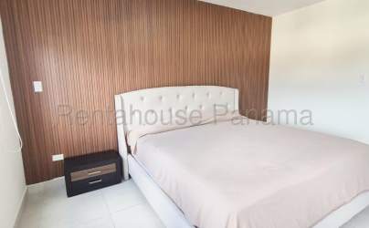 Community swimming pool surrounded by greenery at Las Torres Panama Pacifico