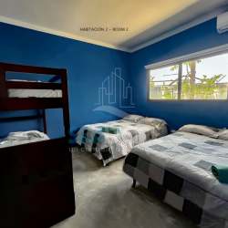 Bedroom with bunk beds and queen beds ideal for vacation rentals in Costa Esmeralda Panama