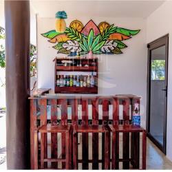 Rustic wood bar area with colorful mural in Costa Esmeralda Panama