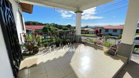 Covered front porch with railing and garden view perfect for relaxing in Los Algarrobos Panama