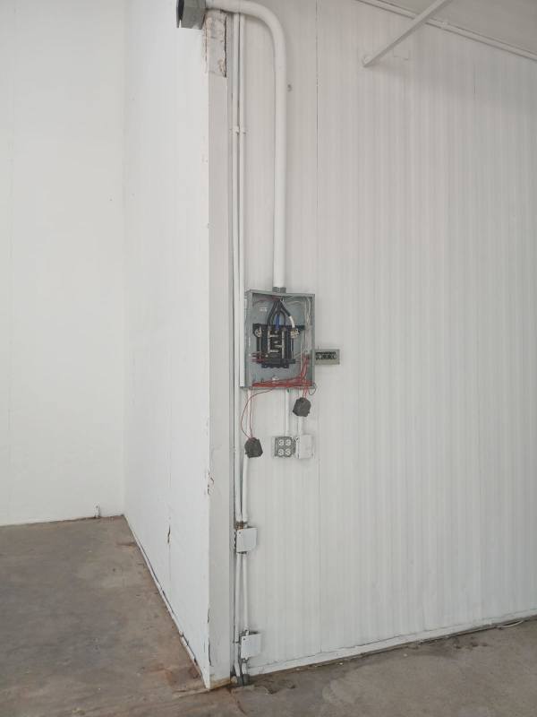 View of industrial warehouse with roll-up steel doors and loading docks in Pedregal Panama