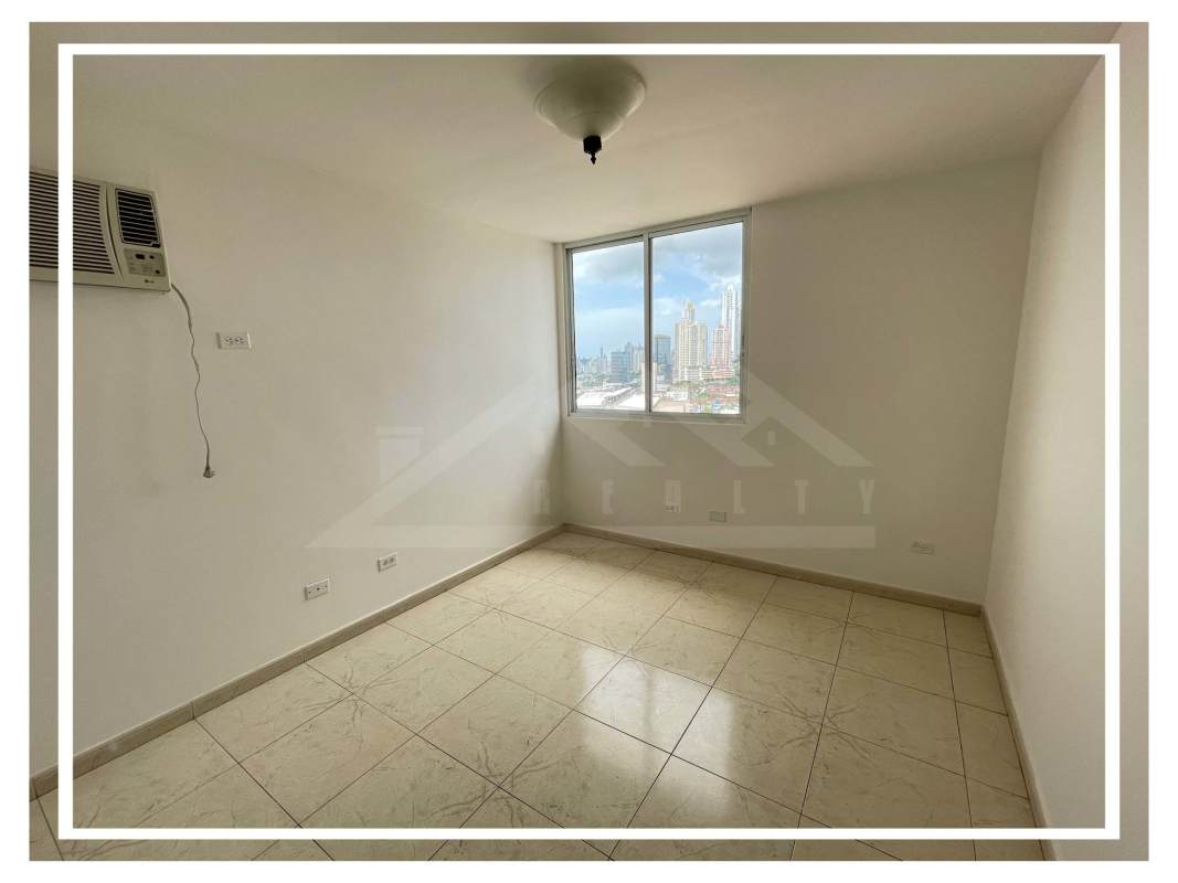 Bedroom with built-in wardrobe, ceramic tile floors, and window view PH El Dorado Panama City