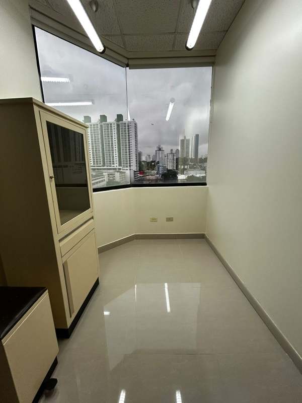 Bright small office with tile flooring and city view window in Panama medical tower