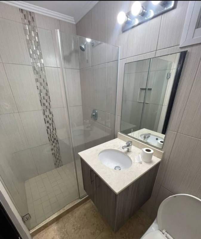 Modern bathroom with glass shower, vanity, and tile PH Cosmopolitan Tower Panama
