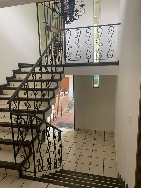 Spacious white kitchen with breakfast table, granite counters, ceiling fan in luxury home San Francisco Panama