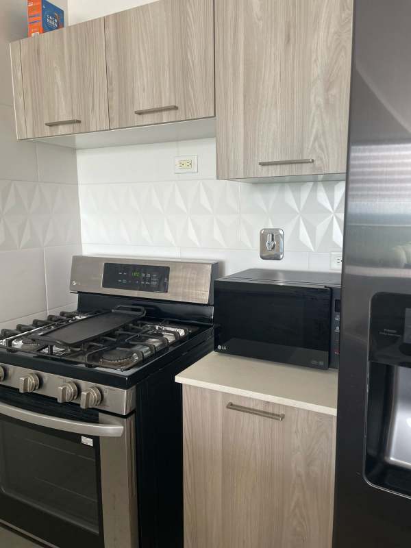 Furnished living room with sliding doors to balcony, mountain city view PH Vivendi Green Edison Park Panama