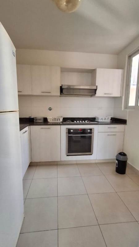Bathroom with walk-in shower, vanity, and tiles at Torres de Versalles Panama