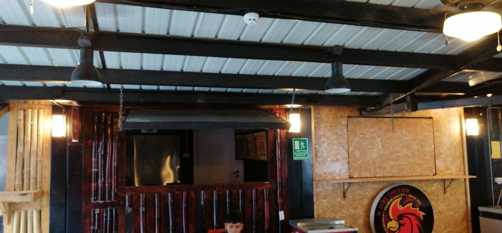 Indoor dining space with hanging pendant lights industrial ceiling Food Bazaar El Cangrejo