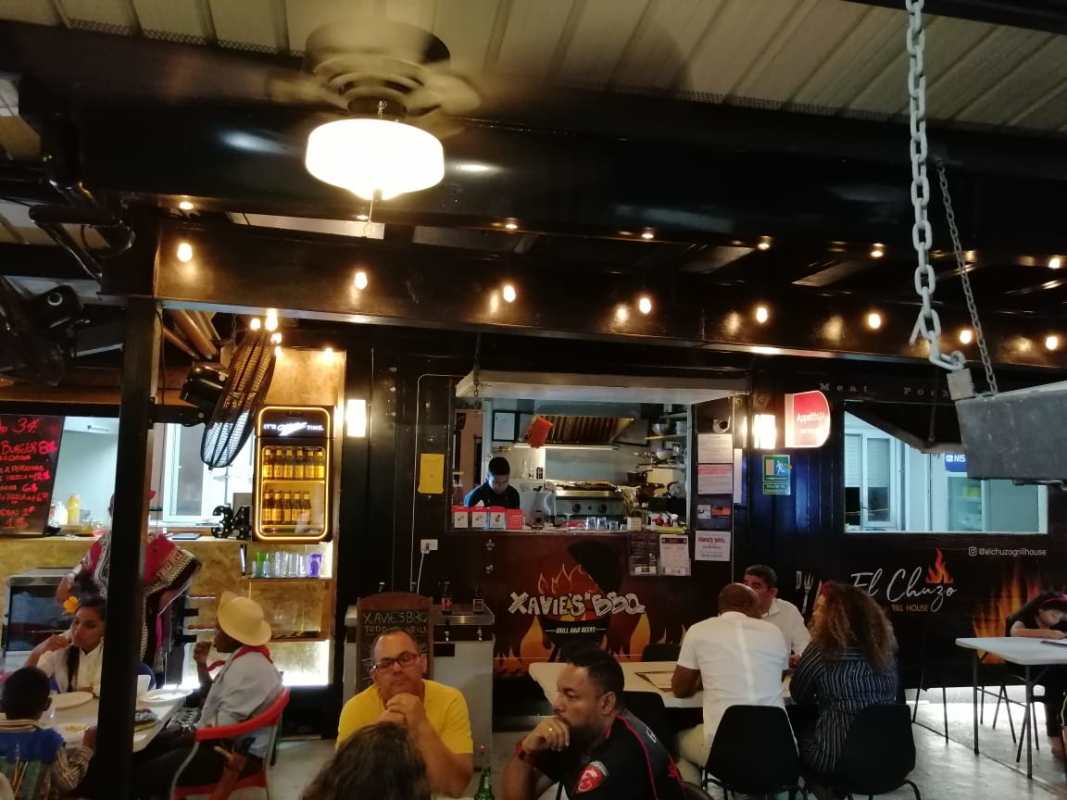 Casual dining interior with string lights and open kitchen Food Bazaar Plaza Panama