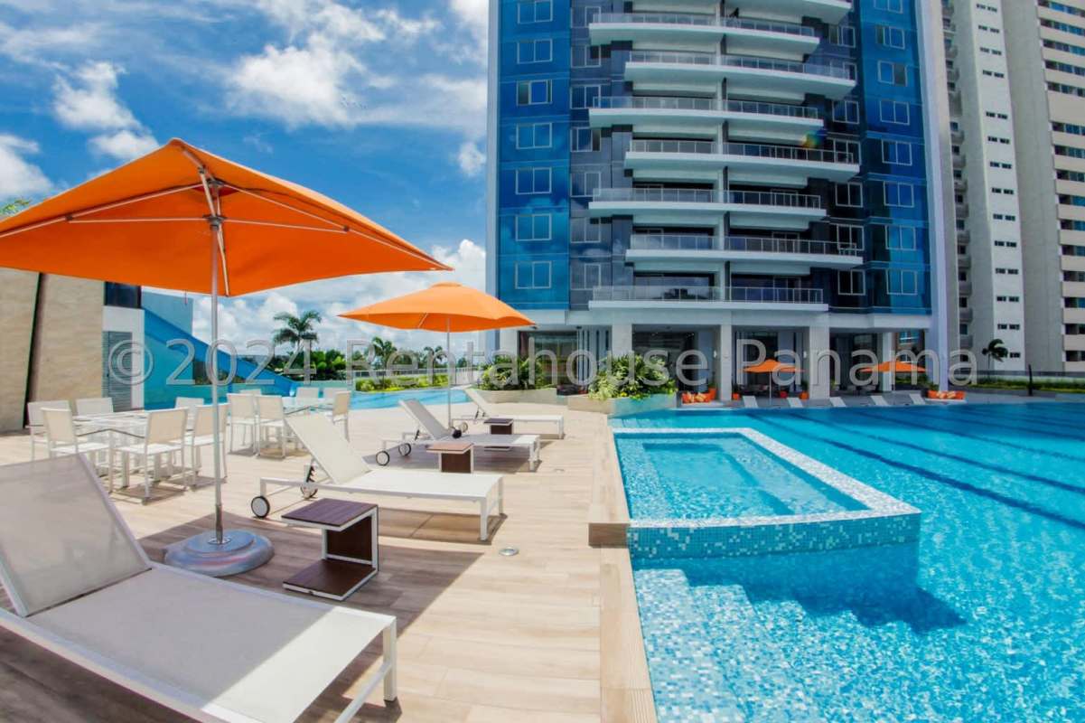 Infinity edge swimming pool with loungers and Pacific Ocean views at Oceania Tower Costa del Este Panama