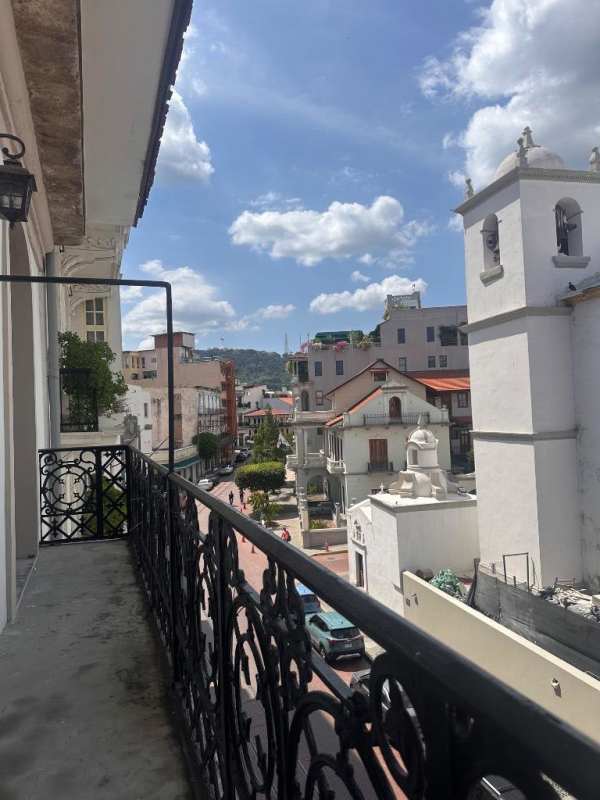Open loft mezzanine level with decorative tiles and railing in Casco Viejo Panama