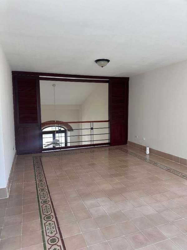Iron balcony overlooks historic street and church tower in Casco Viejo Panama
