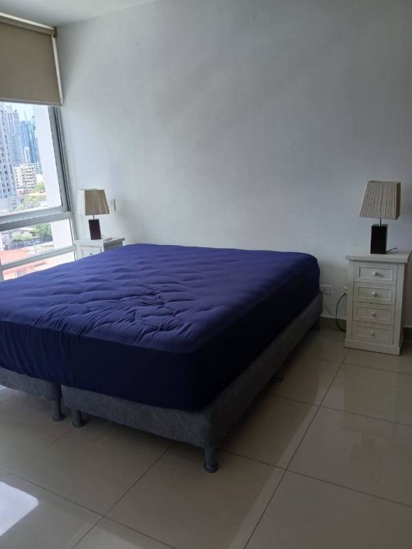 Bedroom with large window, natural light, blue bed cover in PH El Cangrejo Plaza Panama City