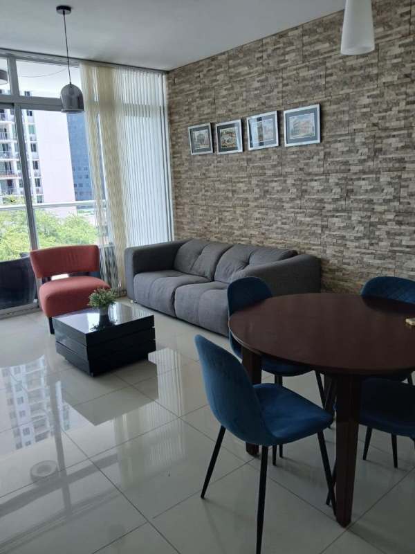 Furnished living-dining area with large windows and urban views in El Cangrejo Panama