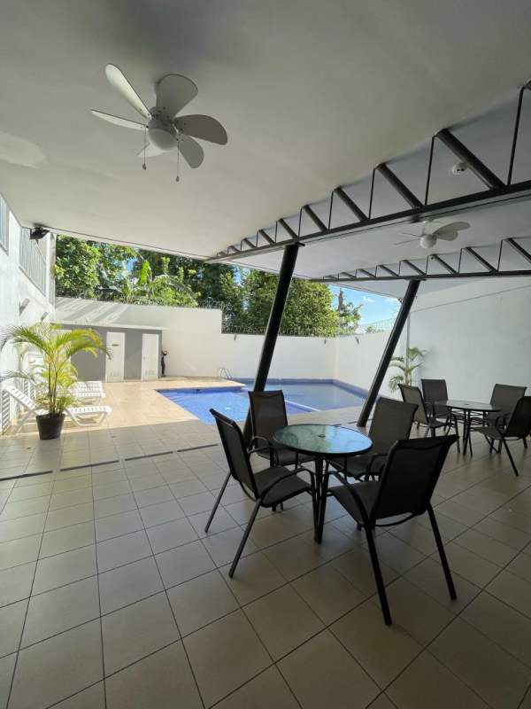 Second bedroom with built-in wardrobe and city view window in PH El Doral Panama