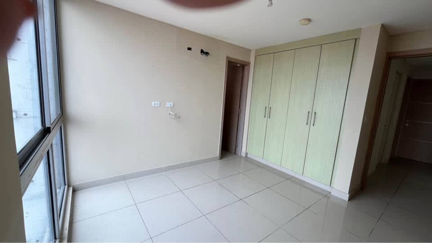 Small bright bedroom with tiled floor and large window PH Torres de Castilla Panama City