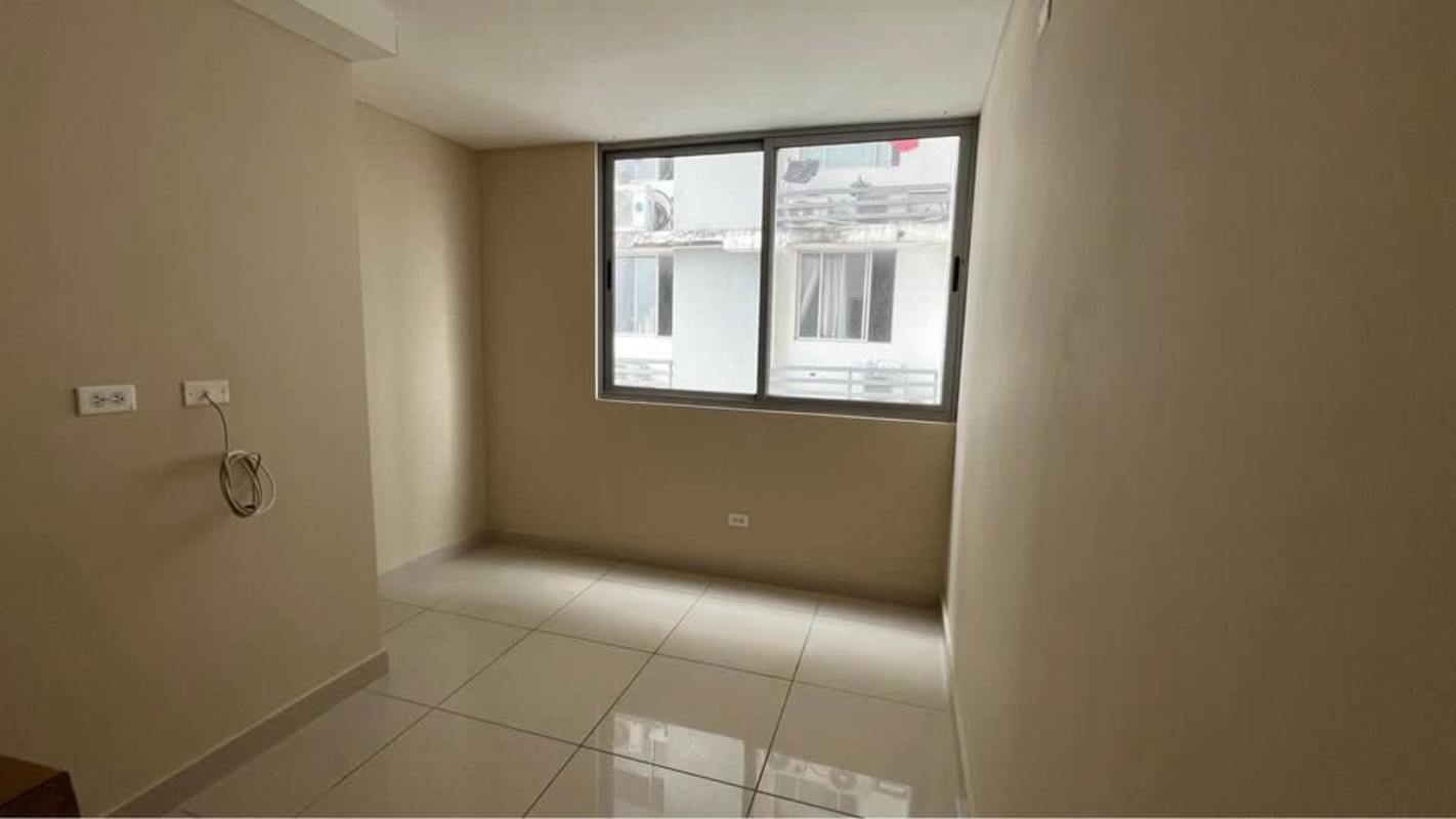 Bright living room with sliding glass doors balcony and city view Panama City